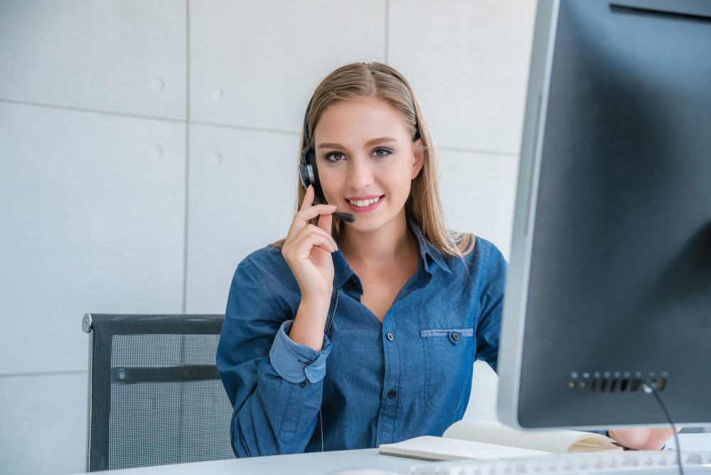 call center worker posing happy accompanied with team. They helping give information to customer and