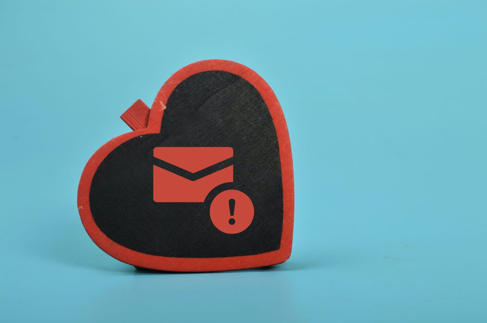 Love board and email symbol. The concept of love scams online involves using email phishing scams
